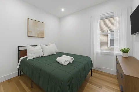 a bedroom with a bed and a window