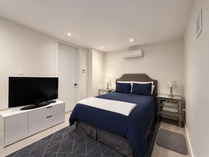 a bedroom with a bed and a flat screen tv