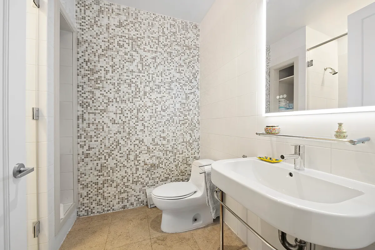 102 Fulton Street, Unit 2E Manhattan, NY 10038 - Photo 6 of 7 a bathroom with a sink toilet and shower