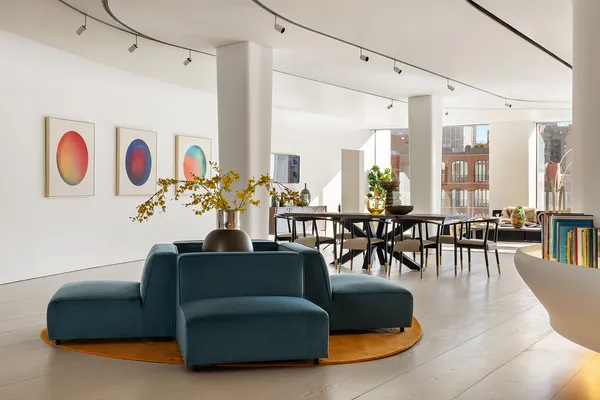 a living room with furniture gym equipment and large windows