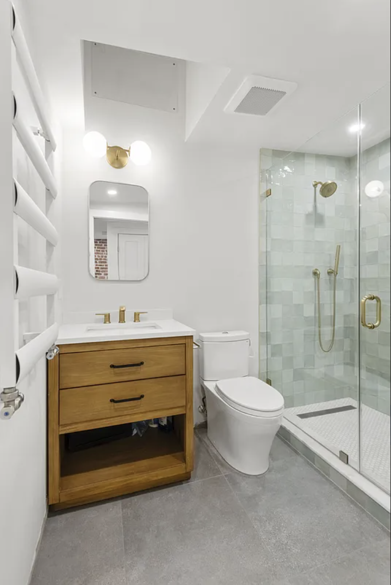 169 Putnam Avenue, Unit 2 Brooklyn, NY 11216 - Photo 7 of 10 a bathroom with a sink a toilet and shower