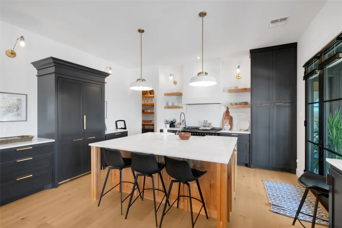 a kitchen with sink a stove and a stove