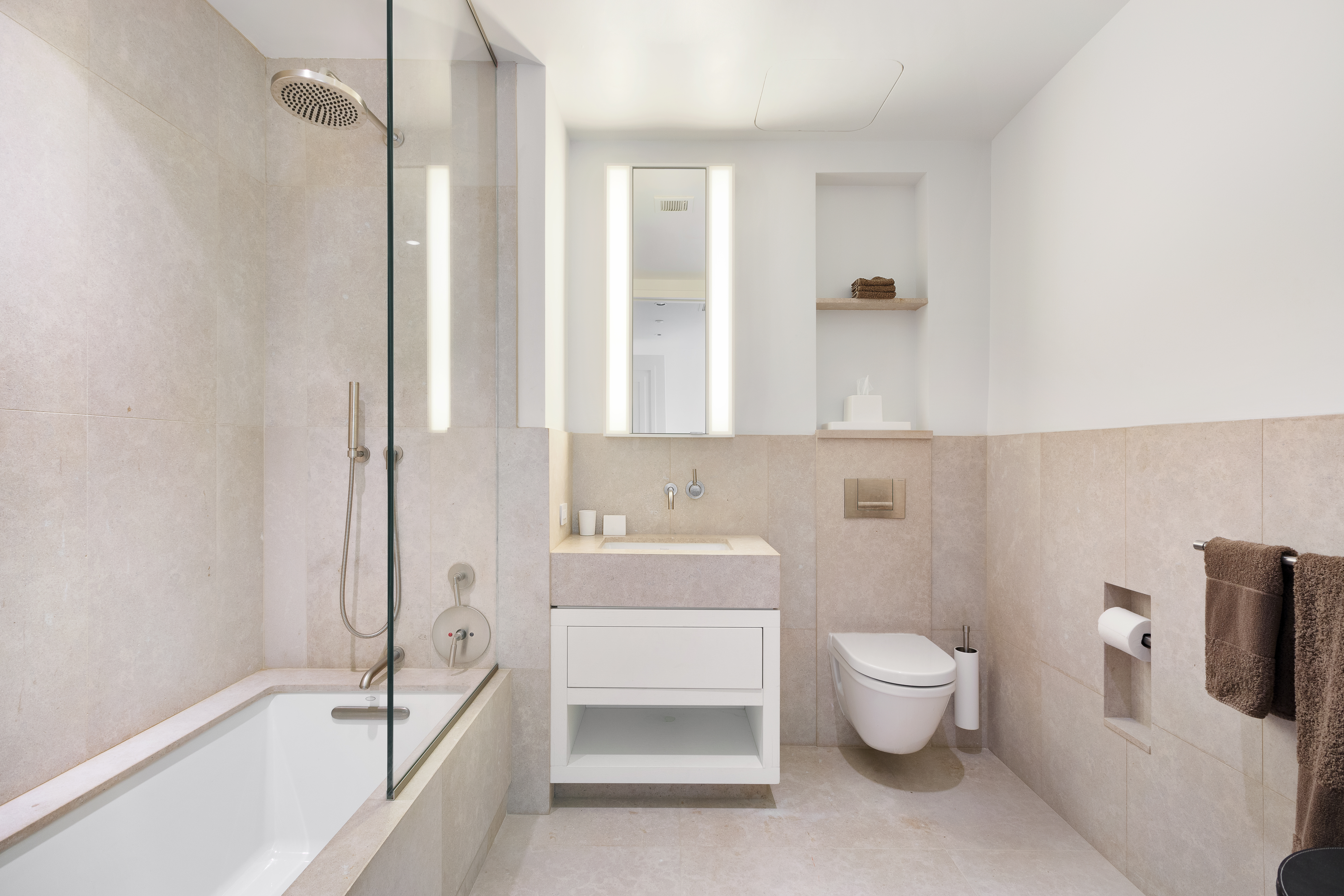 404 Park Avenue South, Unit PH17A Manhattan, NY 10016 - Photo 6 of 9 a bathroom with a sink a toilet and shower