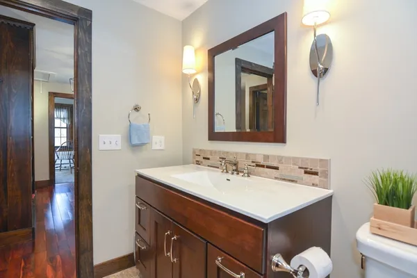 a bathroom with a sink vanity and a mirror