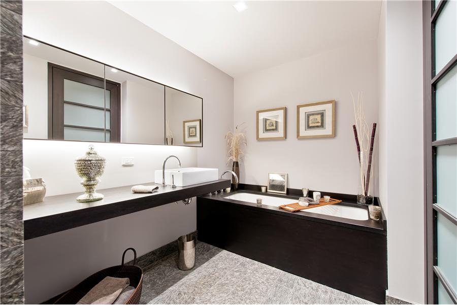 20 Pine Street, Unit 2211 Manhattan, NY 10005 - Photo 5 of 6 a bathroom with a sink and a mirror