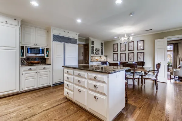 a view of a dining room with furniture a rug and wooden floor