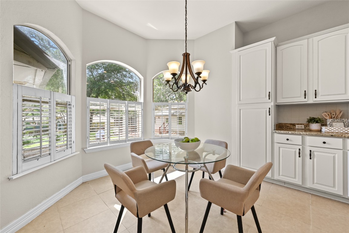 111 Trinity Street Cedar Creek, TX 78612 - Photo 10 of 38 a dining room with furniture a chandelier and wooden floor
