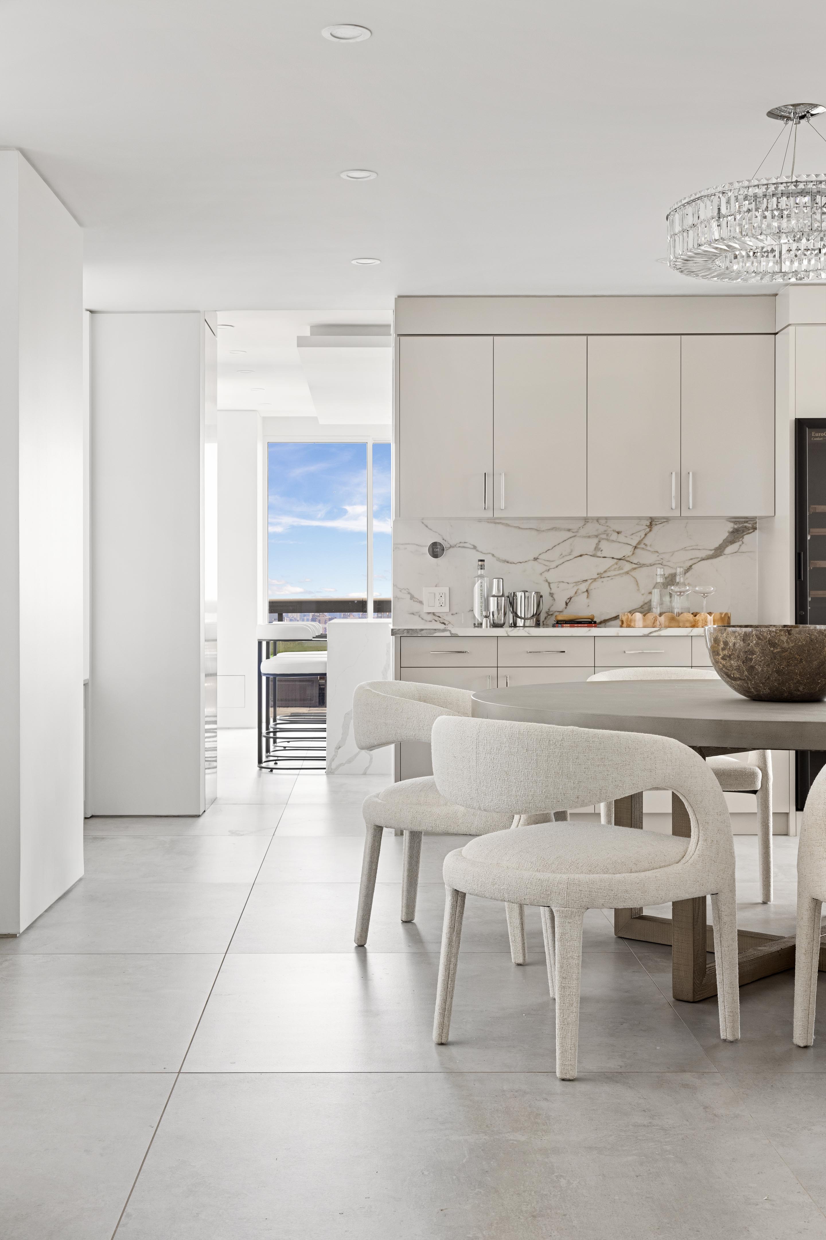 422 East 72nd Street, Unit 37AD Manhattan, NY 10021 - Photo 7 of 38 a kitchen with a sink chairs and cabinets