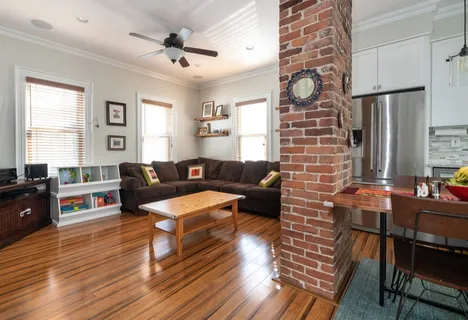 a living room with furniture wooden floor and a table