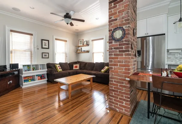a living room with furniture wooden floor and a table