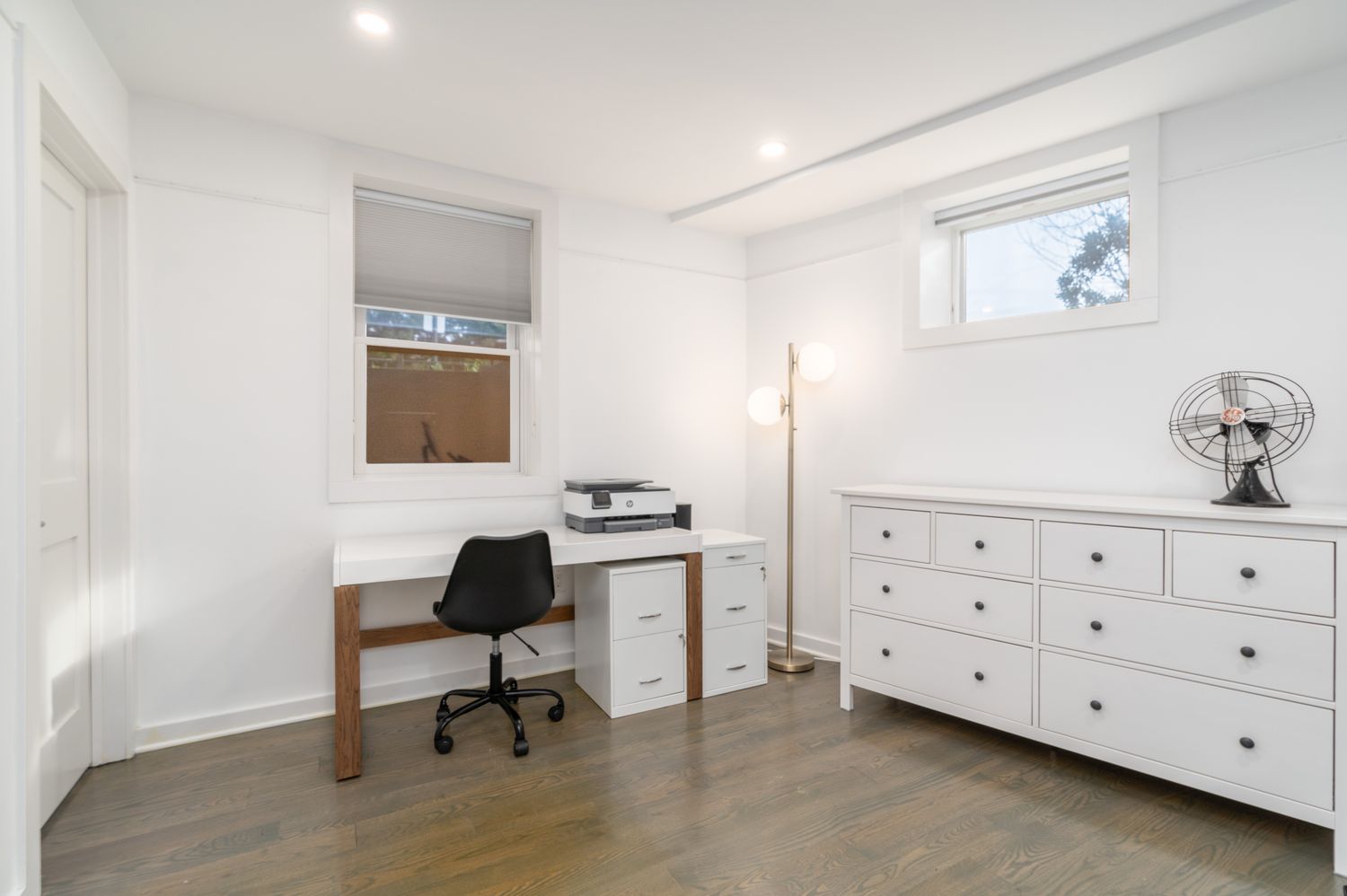 a room with a chair and a dresser in it