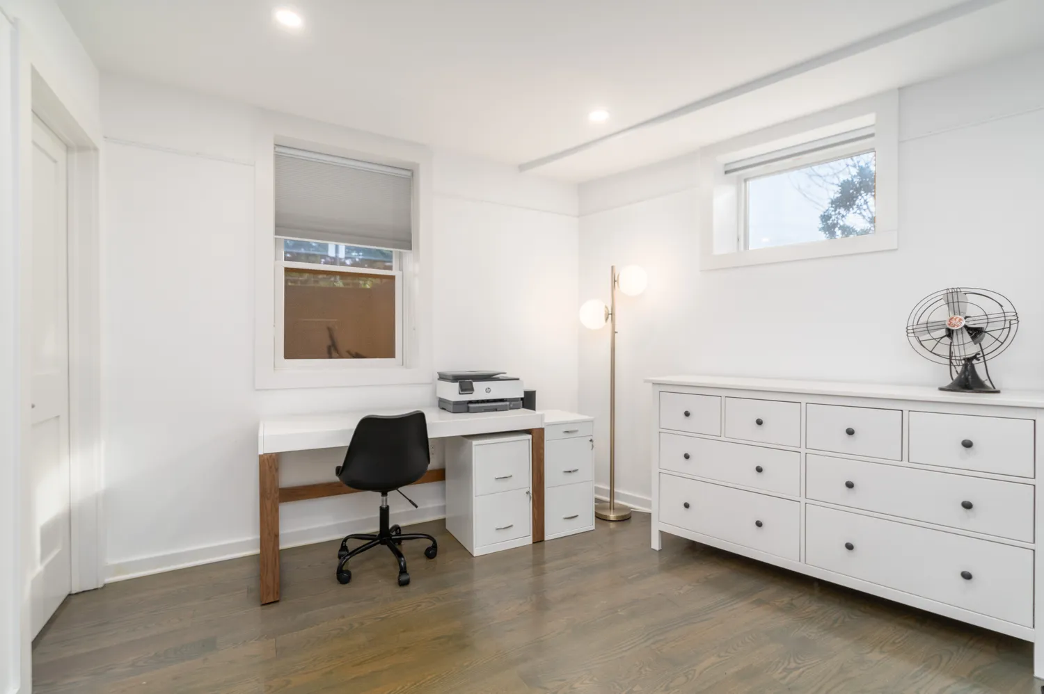 a room with a chair and a dresser in it