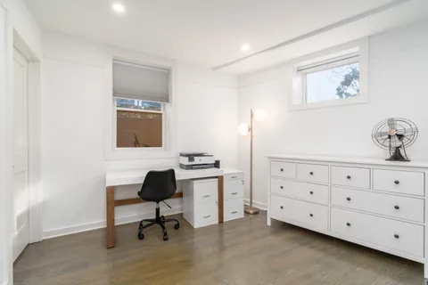 a room with a chair and a dresser in it
