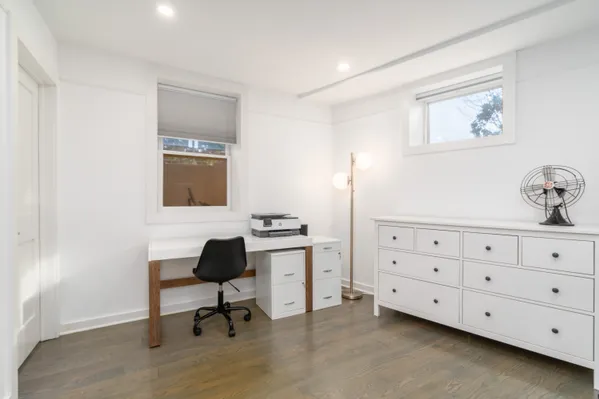 a room with a chair and a dresser in it