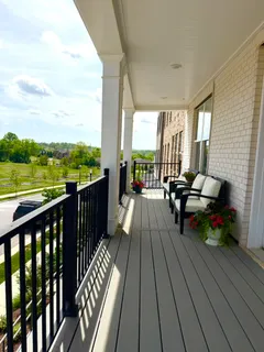 a view of balcony with wooden floor and seating space