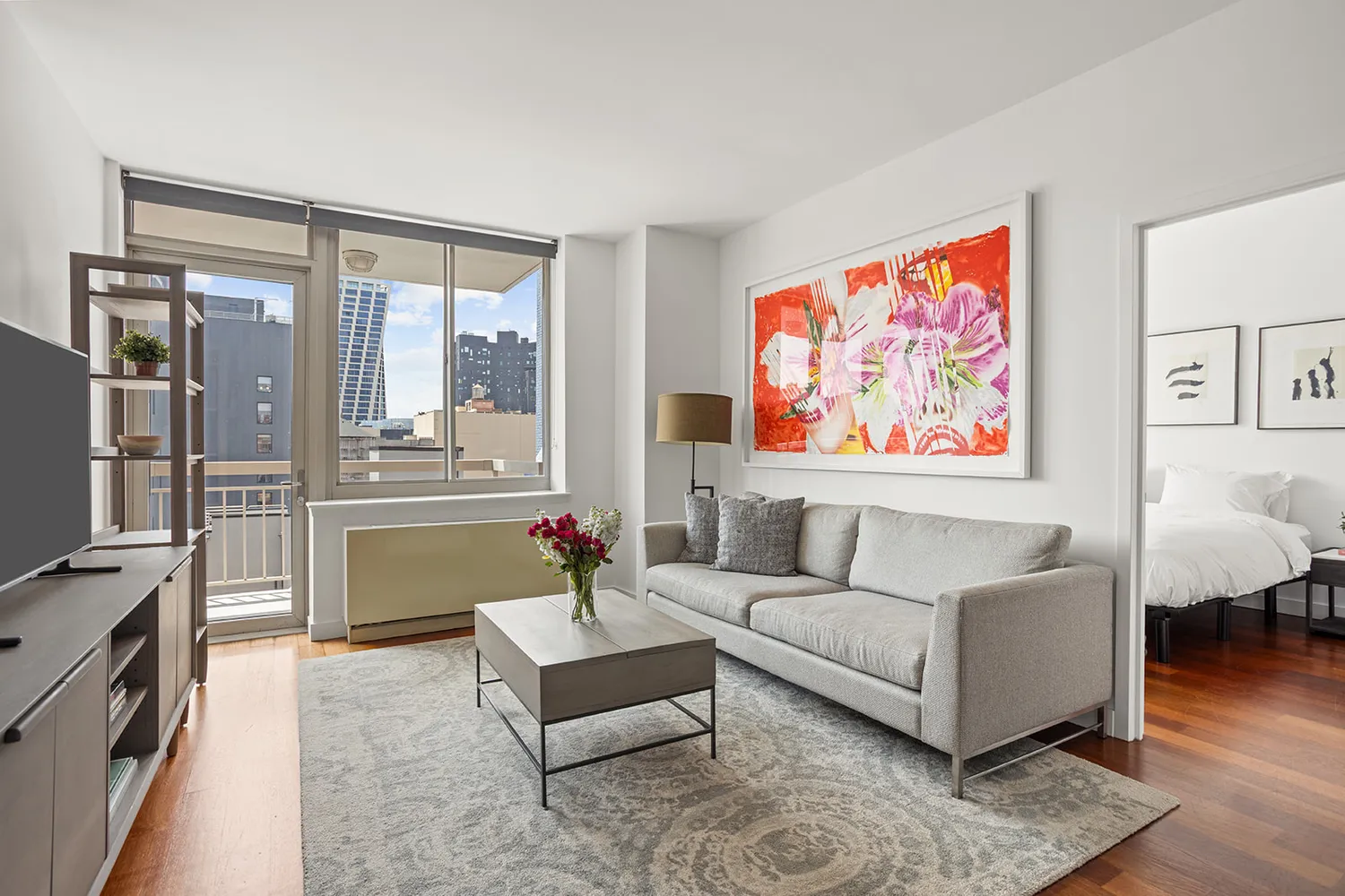 a living room with furniture and a floor to ceiling window