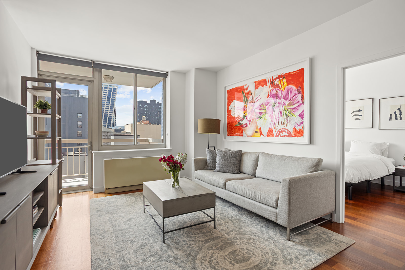 a living room with furniture and a floor to ceiling window