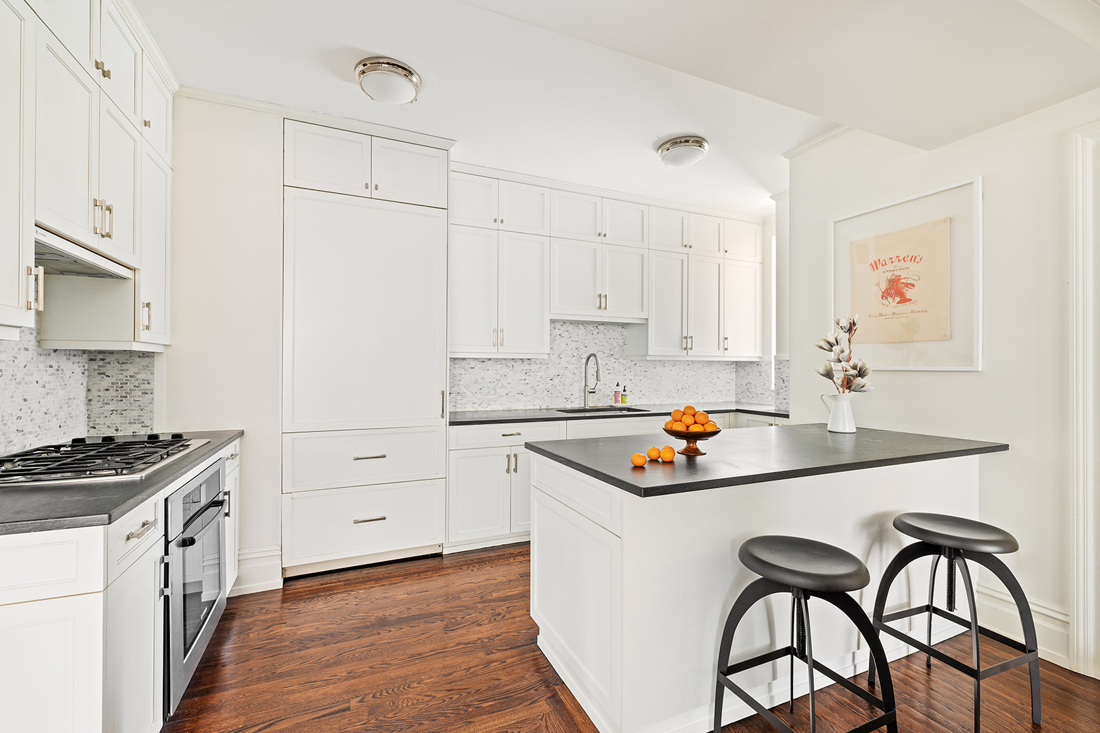 610 West 110th Street, Unit 4D Manhattan, NY 10025 - Photo 3 of 12 a kitchen with granite countertop a sink stove and white cabinets with wooden floor