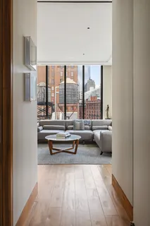 a living room with furniture and large windows