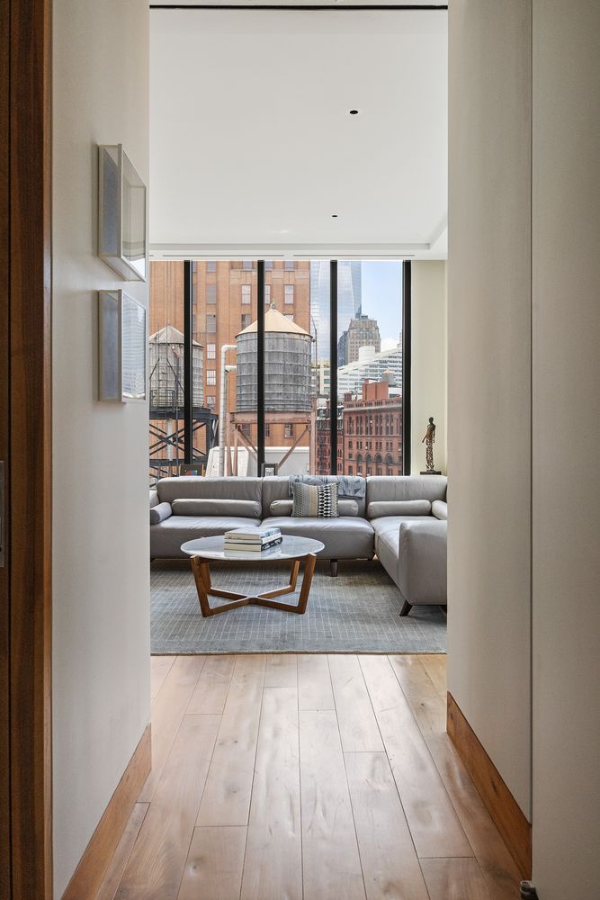 a living room with furniture and large windows