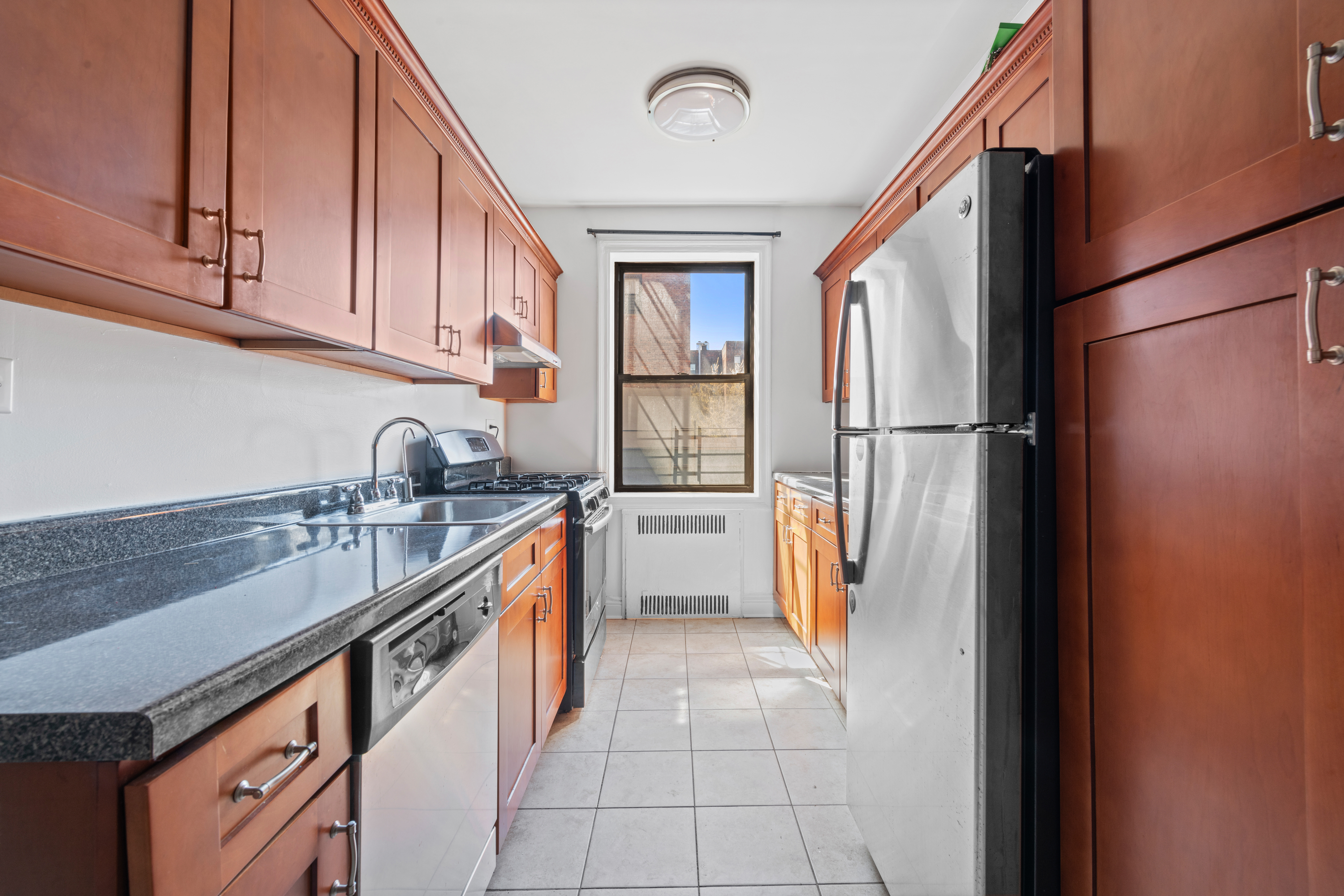 40 Clarkson Avenue Brooklyn, NY 11226 - Photo 16 of 18 a kitchen with stainless steel appliances granite countertop a refrigerator and a sink