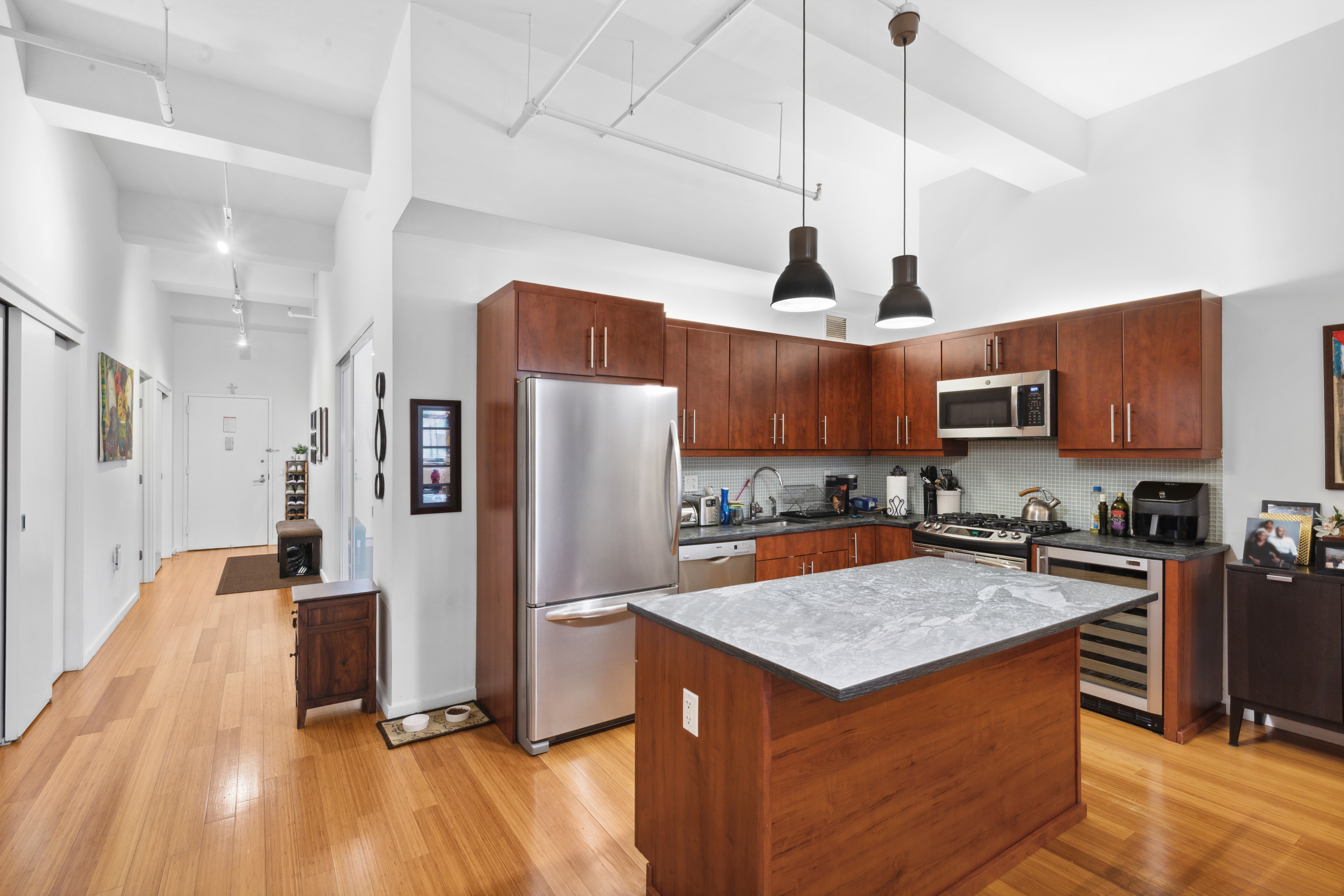 365 Bridge Street, Unit 12H Brooklyn, NY 11201 - Photo 2 of 12 a kitchen with stainless steel appliances granite countertop a refrigerator a sink dishwasher a stove and a wooden floor