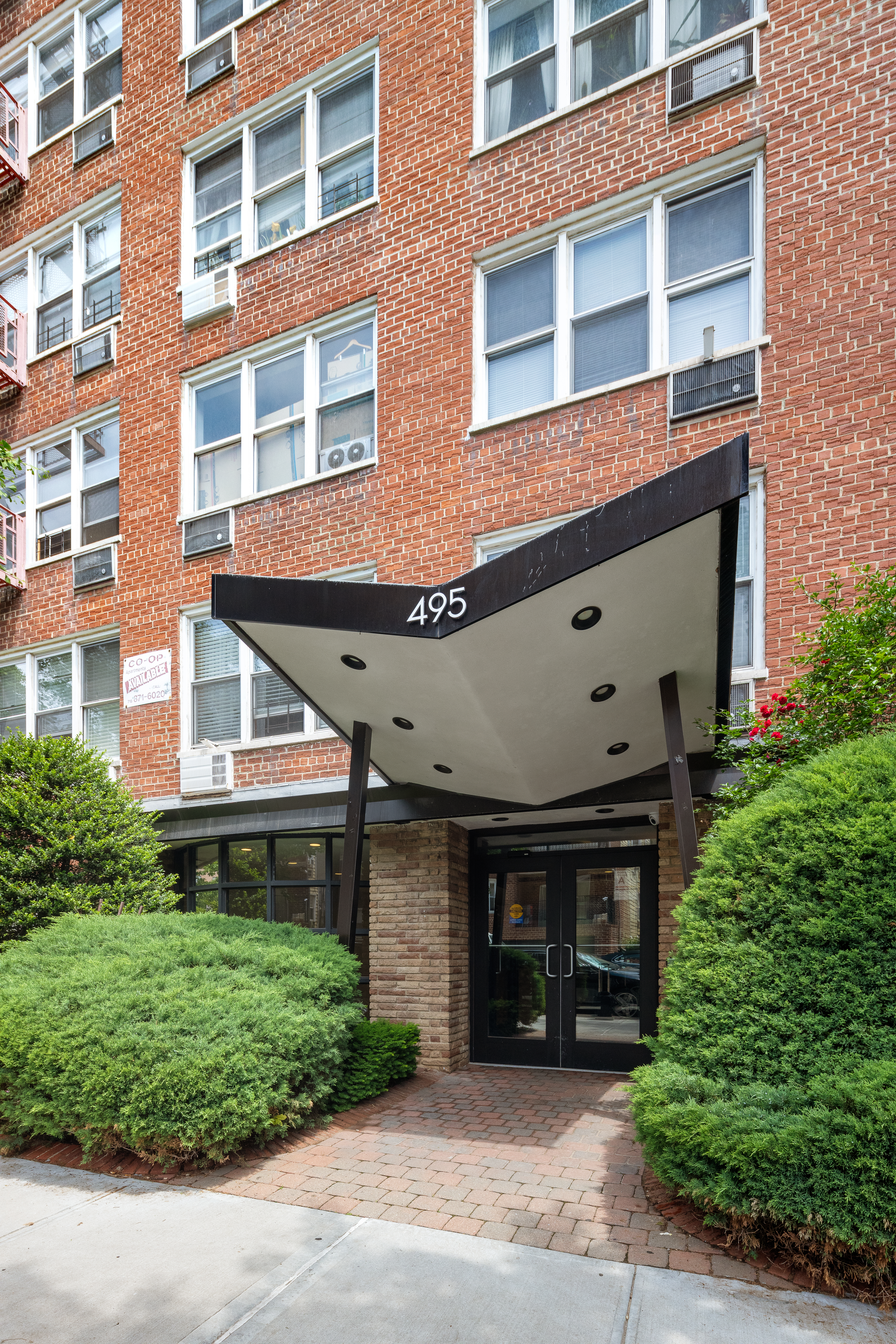 495 East 7th Street, Unit 2F Brooklyn, NY 11218 - Photo 9 of 10 a front view of a building with a garden
