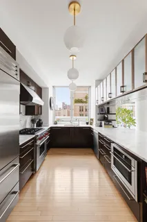 a kitchen with stainless steel appliances a stove sink and cabinets
