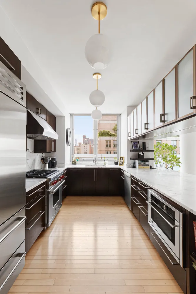 a kitchen with stainless steel appliances a stove sink and cabinets