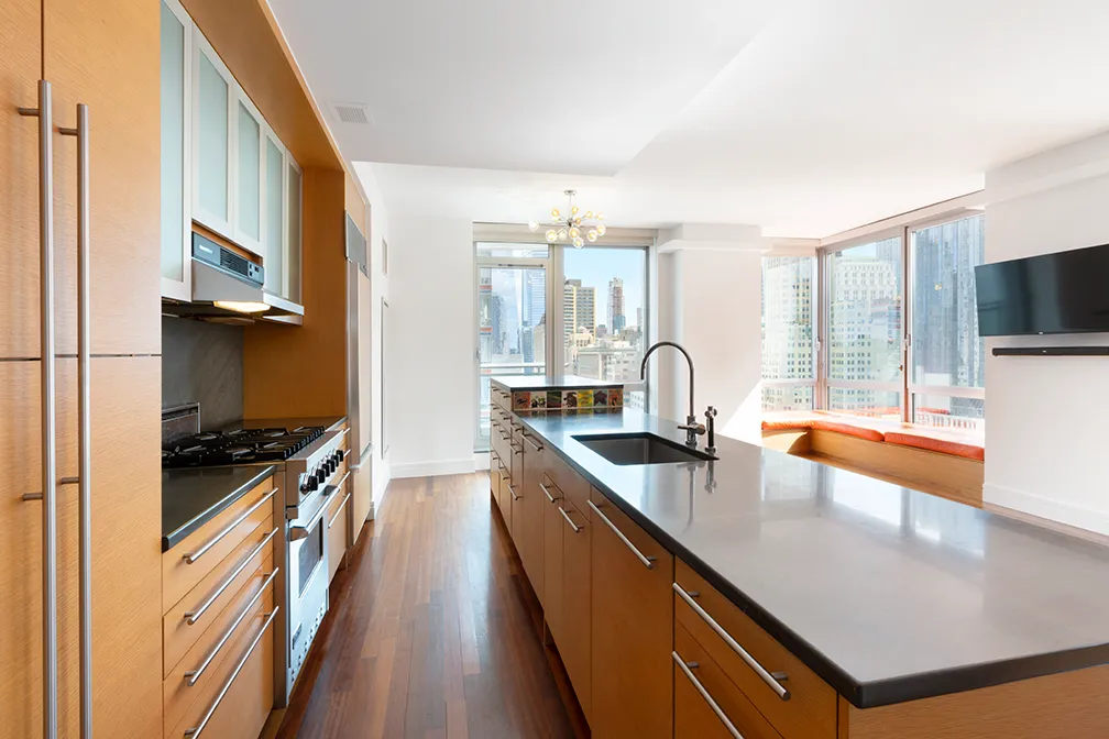 a kitchen with stainless steel appliances a sink a stove and a refrigerator