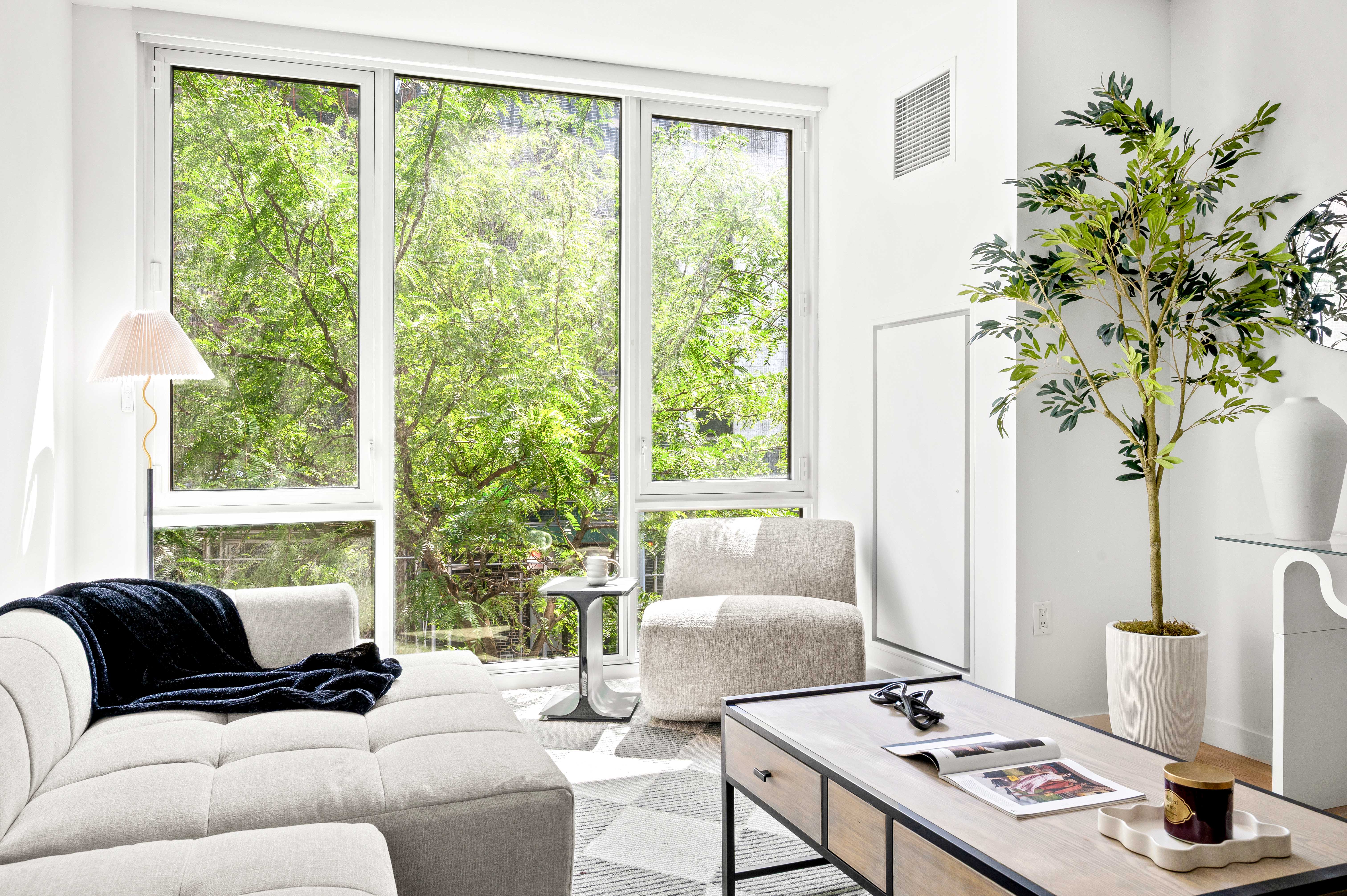 540 West 49th Street, Unit 306S Manhattan, NY 10019 - Photo 3 of 13 a living room with furniture and a window