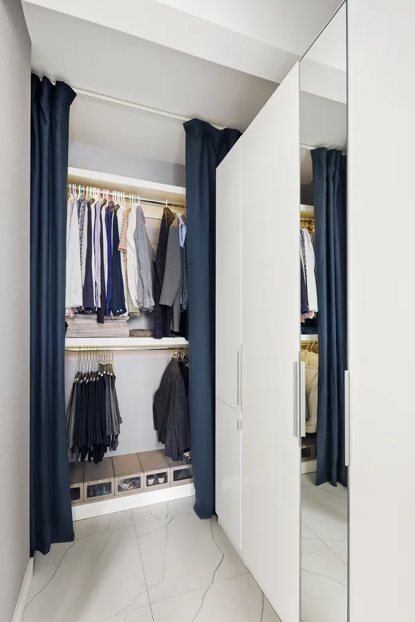 a view of walk in closet with clothes and shoes