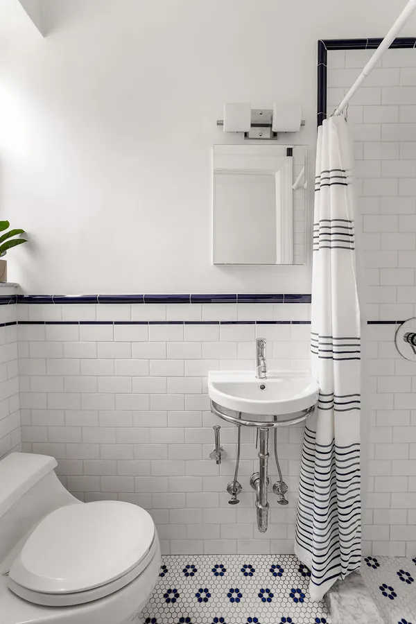 a bathroom with a sink a toilet and mirror