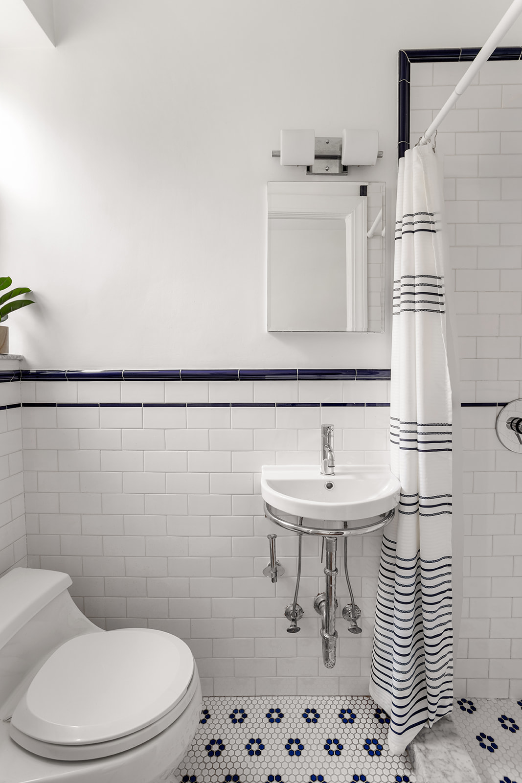 35-47 80th Street, Unit 21 Queens, NY 11372 - Photo 8 of 14 a bathroom with a sink a toilet and mirror