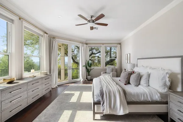 a spacious bedroom with a bed and a large window