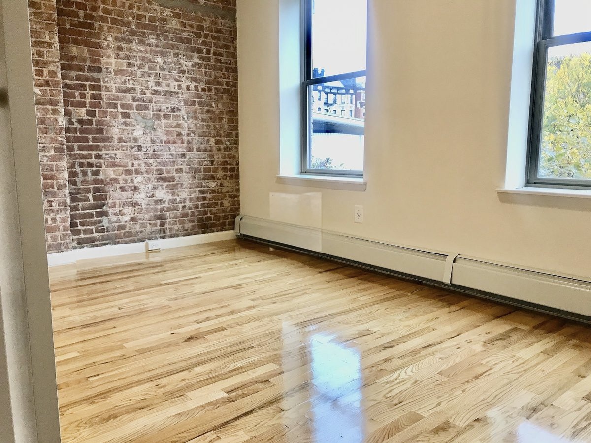 Convent Avenue Manhattan, NY 10031 - Photo 5 of 12 a view of a room with wooden floor and windows