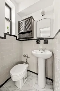 a bathroom with a sink toilet and mirror