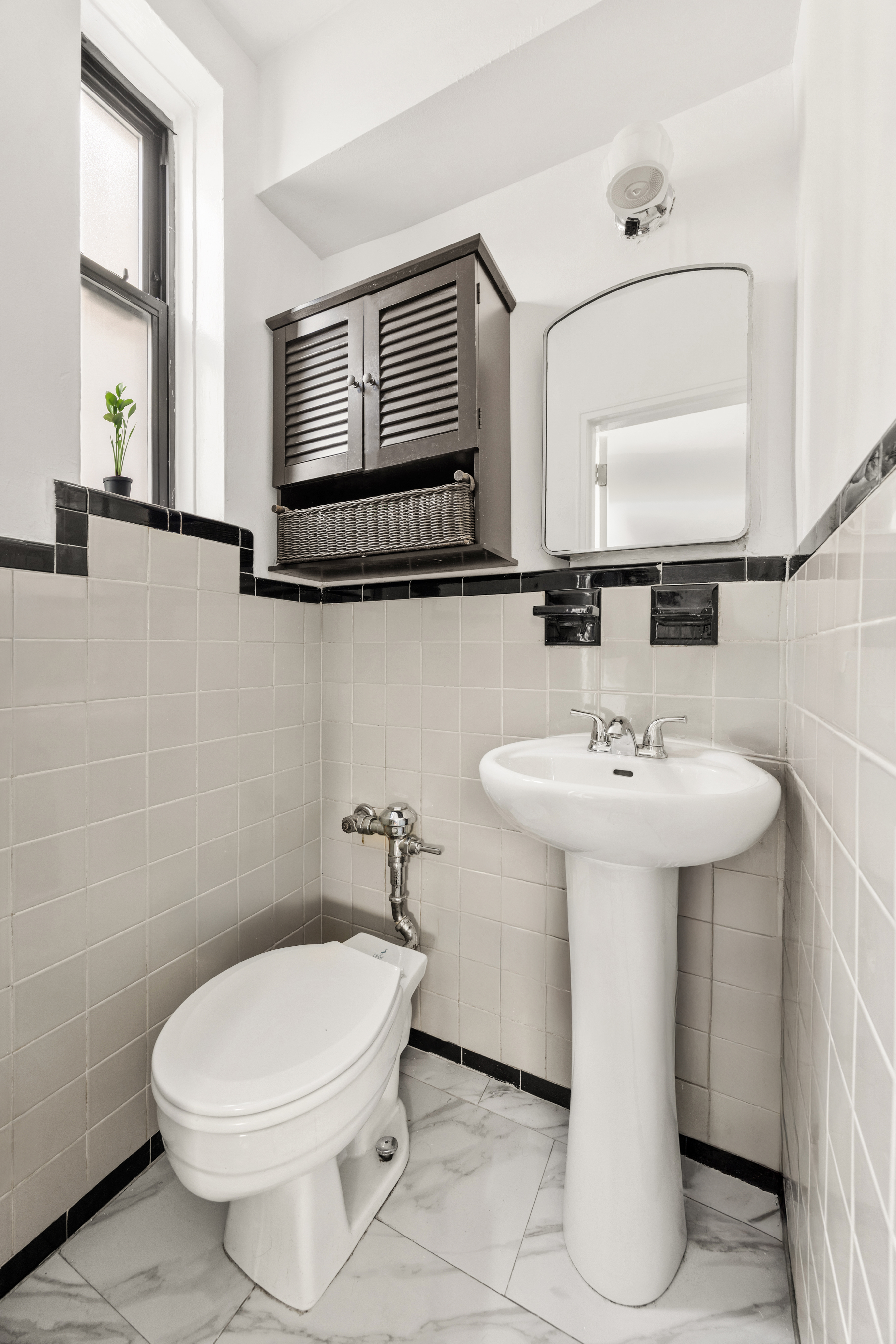 345 Webster Avenue, Unit 1B Brooklyn, NY 11230 - Photo 7 of 13 a bathroom with a sink toilet and mirror
