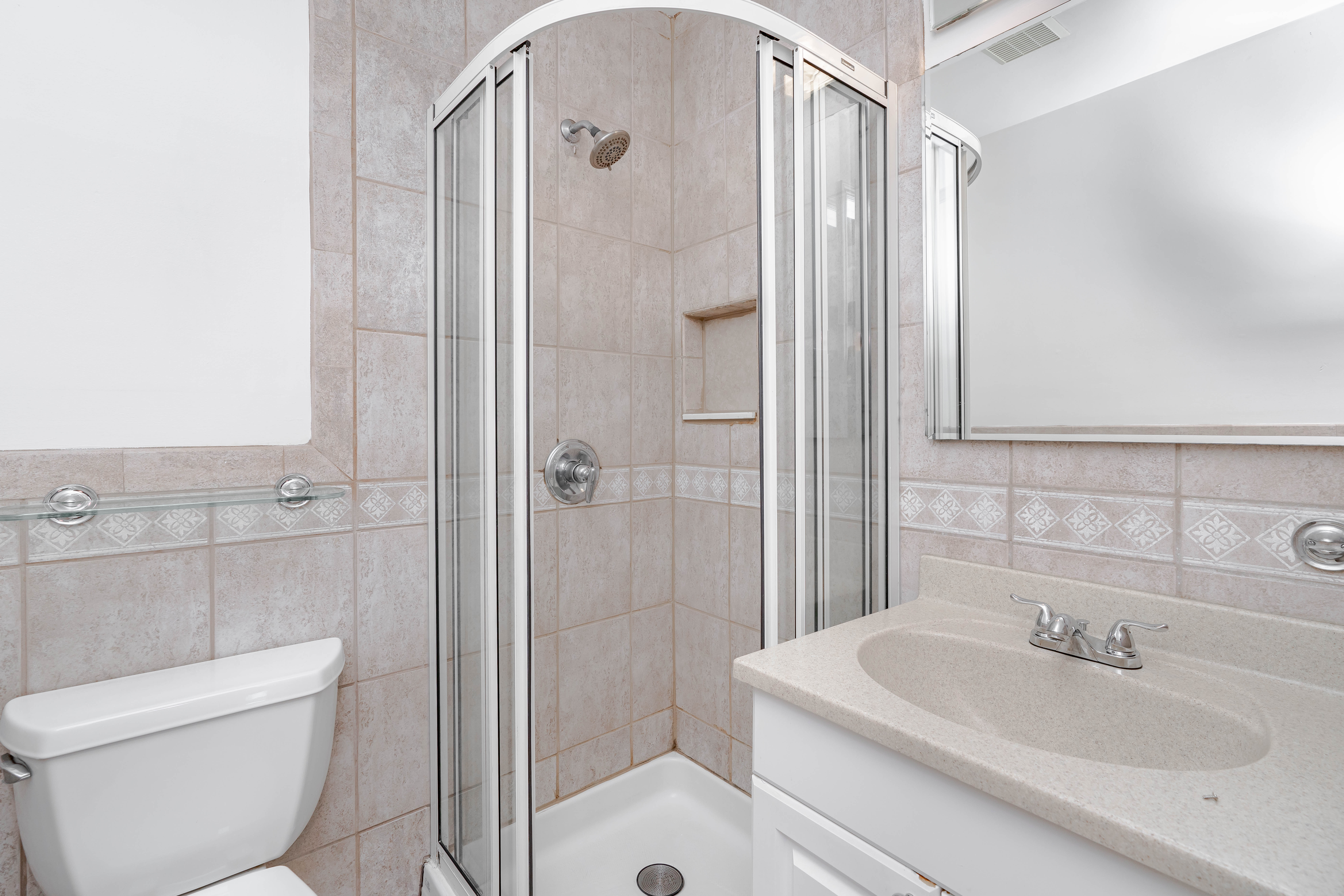 15-80 209th Street, Unit 2 Queens, NY 11360 - Photo 10 of 11 a bathroom with a sink toilet and shower