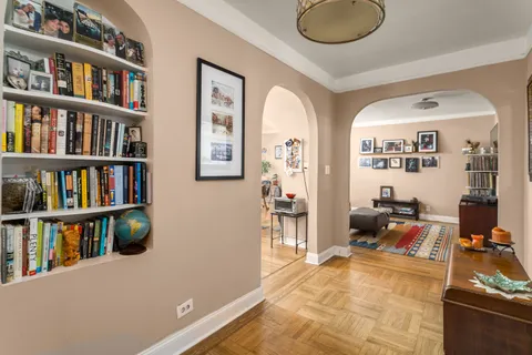 a view of living room with furniture and book shelf