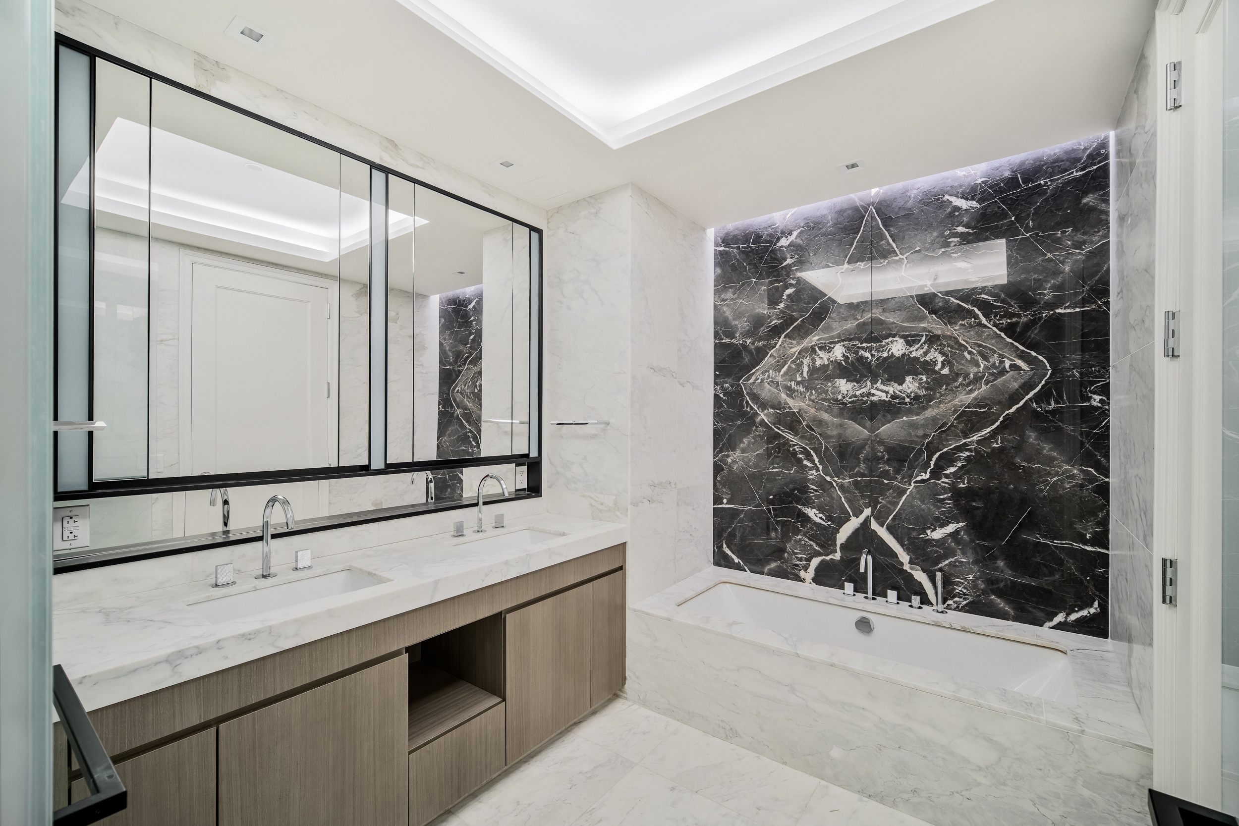 108 Leonard Street, Unit 12F Manhattan, NY 10013 - Photo 7 of 15 a bathroom with a double vanity sink mirror and shower