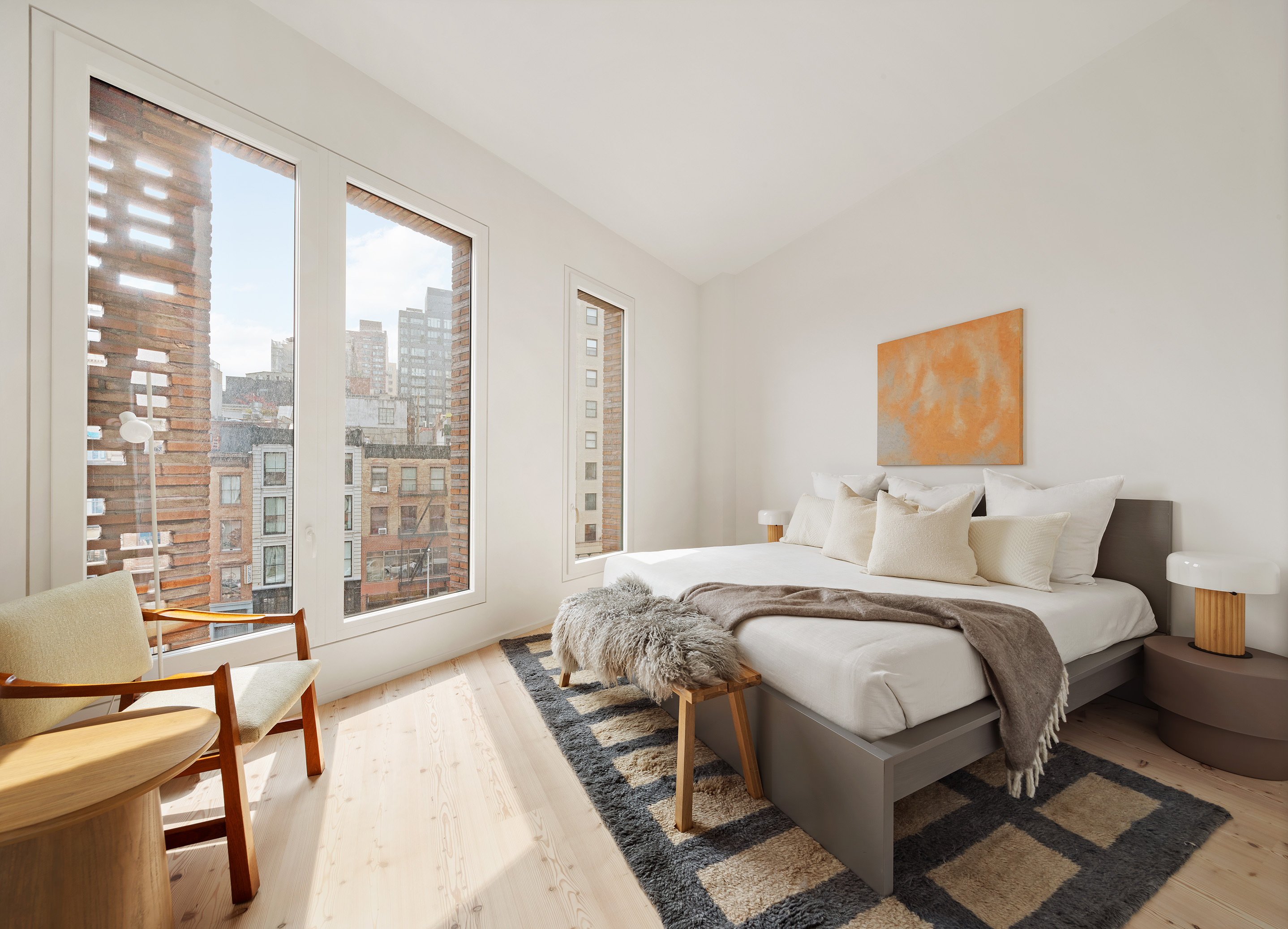 1 Avenue Of The Americas, Unit 5N Manhattan, NY 10013 - Photo 10 of 17 a bedroom with a bed and a couch next to a window