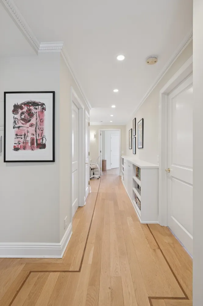 a view of a hallway with wooden floor
