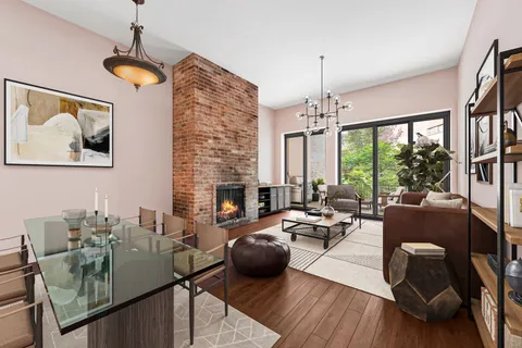 a living room with furniture fireplace and a large window