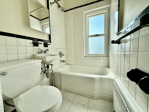 a bathroom with a sink a toilet and bathtub