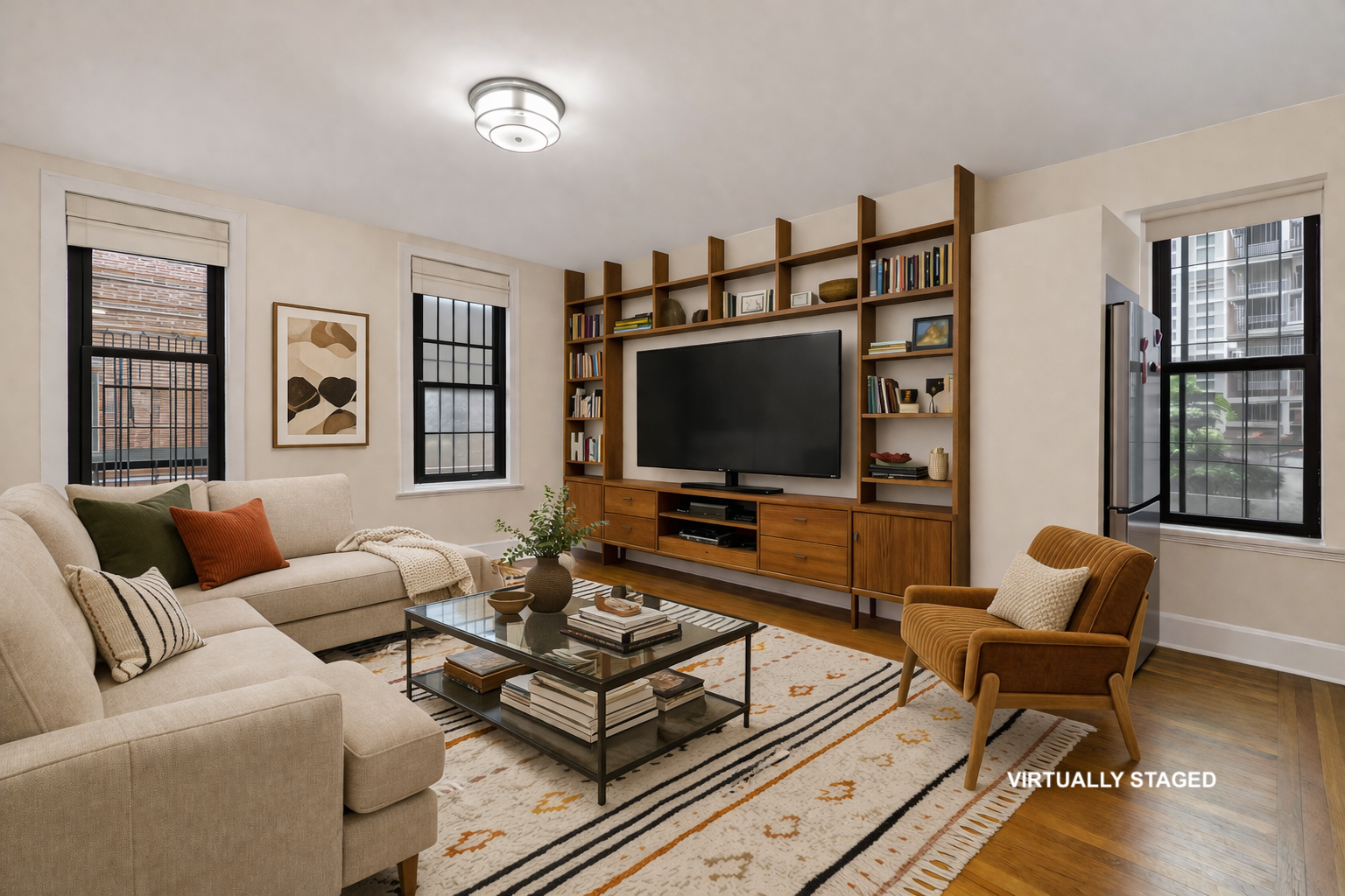 26 West 97th Street, Unit 2C Manhattan, NY 10025 - Photo 1 of 9 a living room with furniture and a flat screen tv
