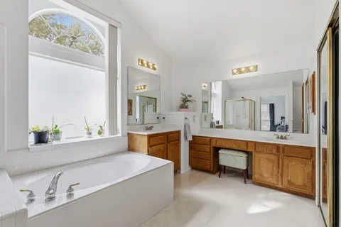 a large bathroom with a double vanity sink and a mirror