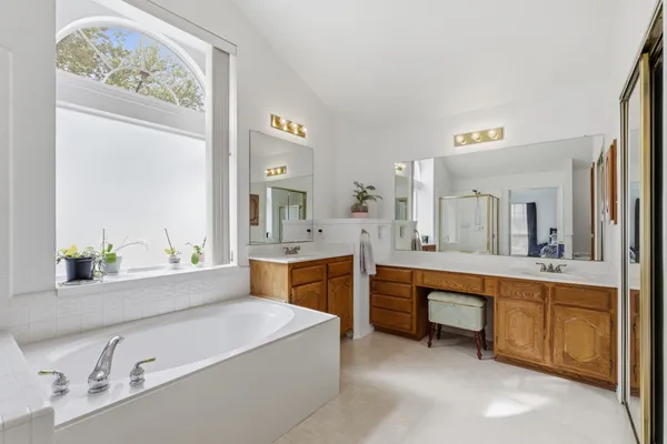 a large bathroom with a double vanity sink and a mirror