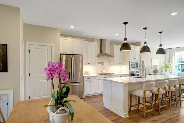 a kitchen with stainless steel appliances granite countertop sink cabinets and wooden floor