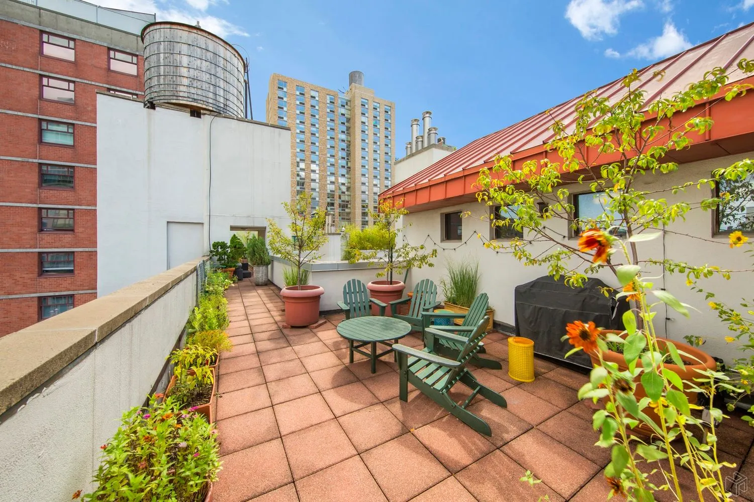 a balcony with furniture and flowers